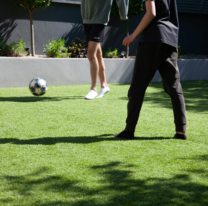 People splaying soccer on artificial turf